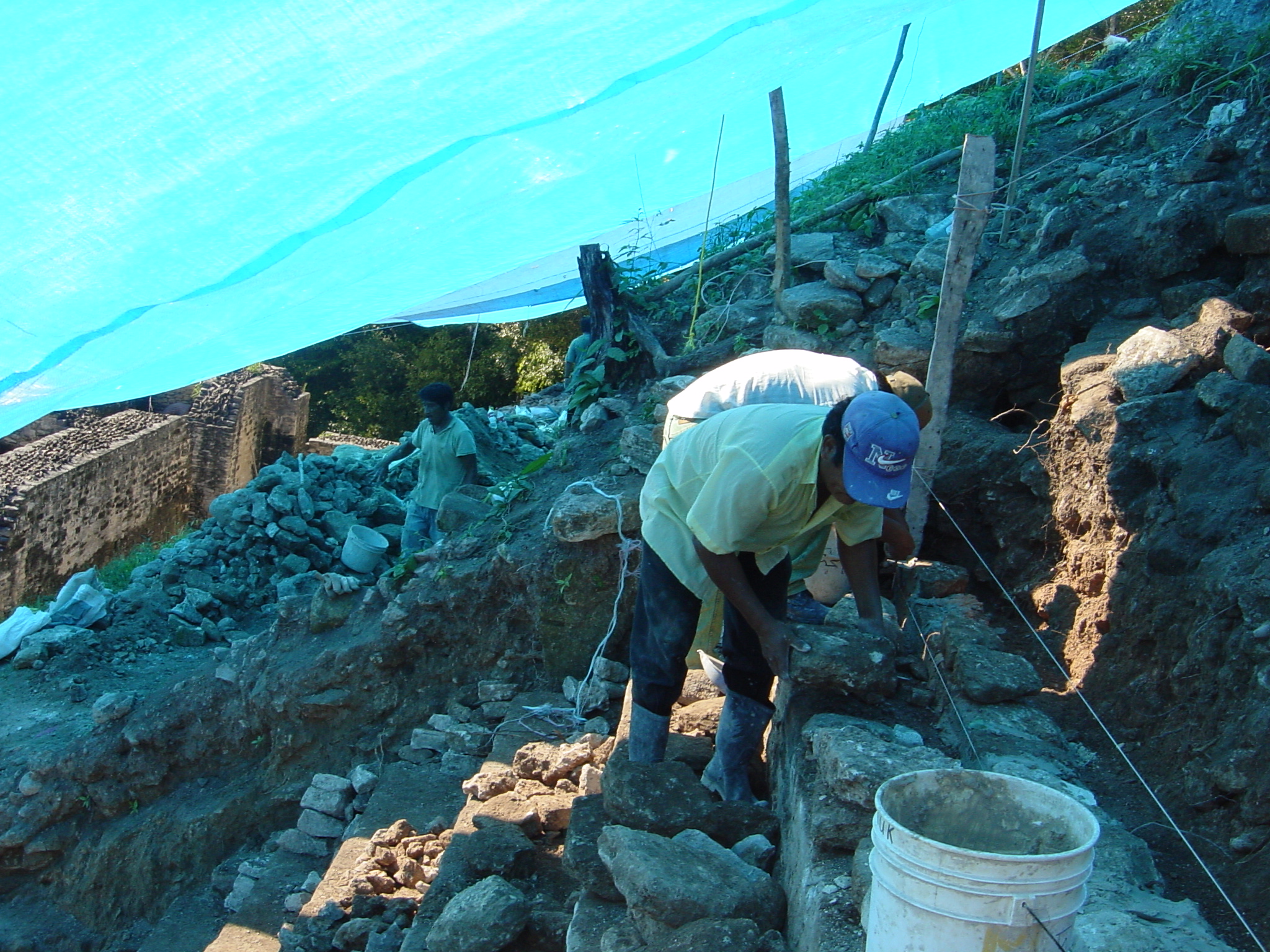 workers using historic methods and modern concrete to fix the ruins